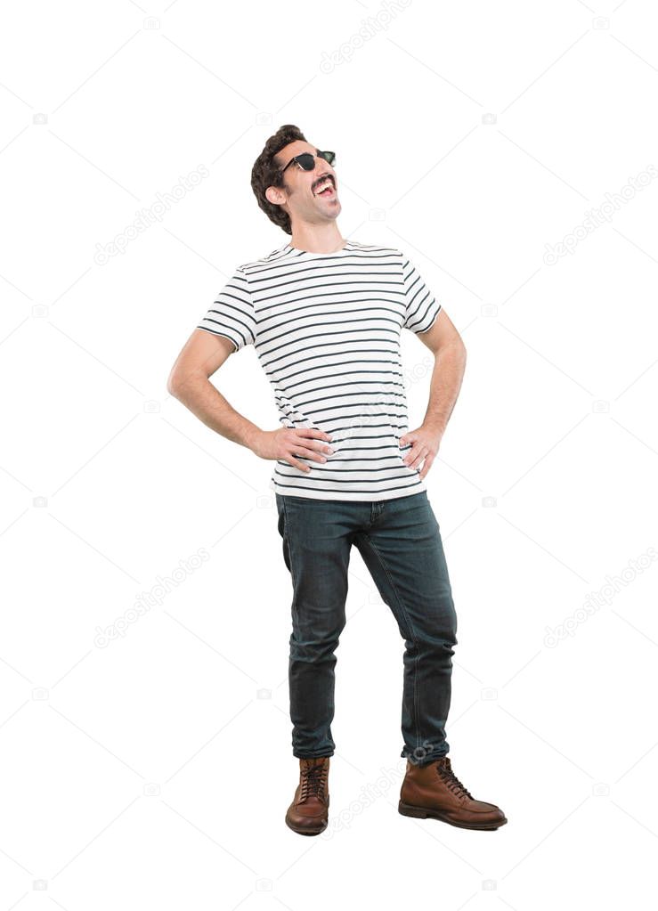 young crazy man in proud pose. Full body cutout person against white background.