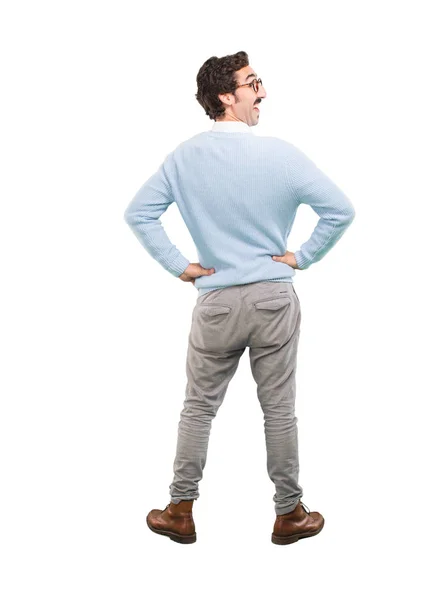 Young crazy man with satisfied expression and pose. Full body cutout person against white background.