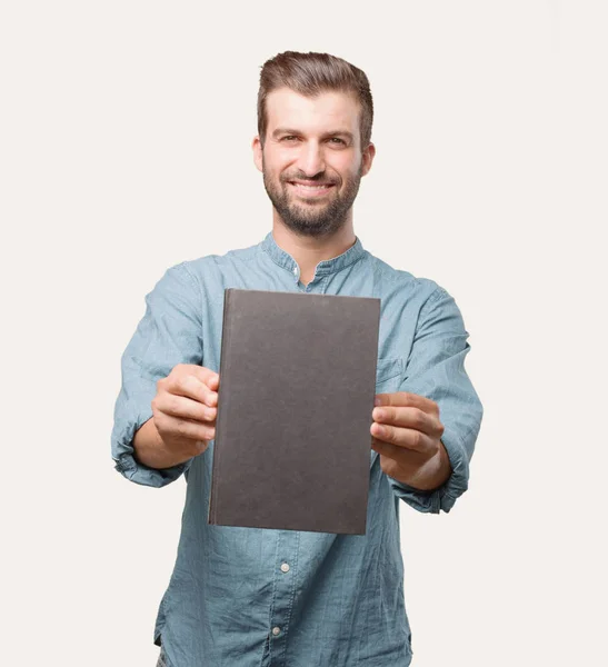 Joven Hombre Guapo Camisa Mezclilla Azul Sosteniendo Libro Expresión Sorprendida — Foto de Stock