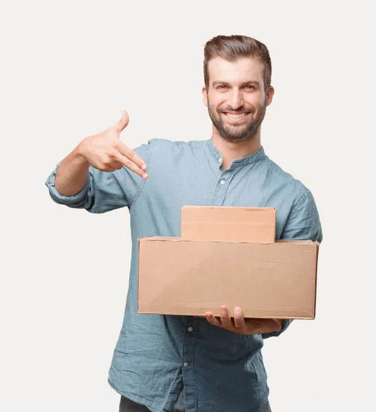 Joven Hombre Guapo Camisa Mezclilla Azul Sosteniendo Paquete Feliz Expresión —  Fotos de Stock