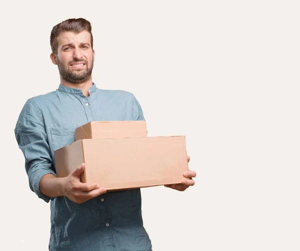 Ung Stilig Man Blå Jeansskjorta Håller Ett Paket Stressad Eller — Stockfoto