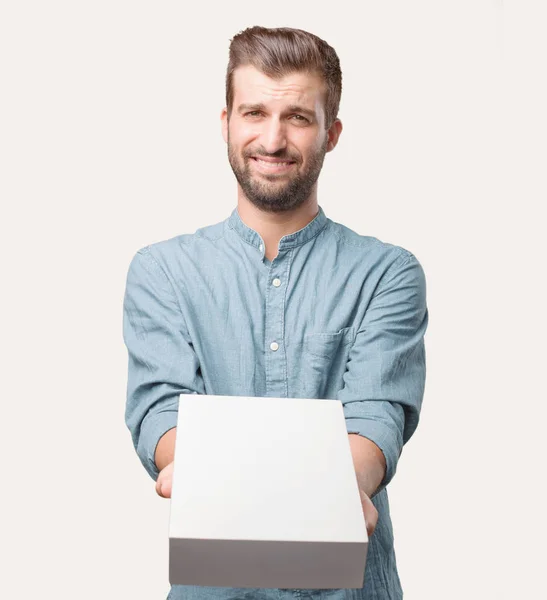 Joven Hombre Guapo Camisa Mezclilla Azul Sosteniendo Paquete Feliz Expresión —  Fotos de Stock