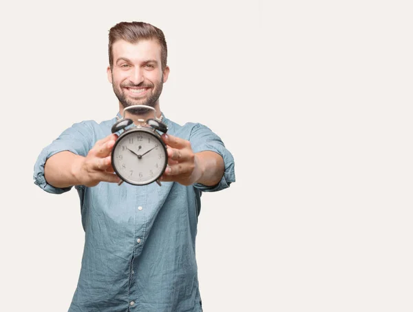 Joven Hombre Guapo Sosteniendo Reloj Despertador Con Una Camisa Mezclilla — Foto de Stock