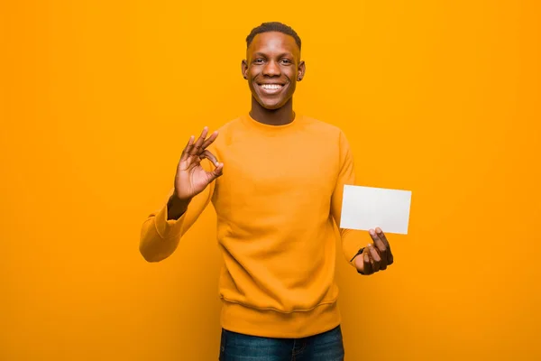 Young African American Black Man Orange Wall Wholding Placard — Stock Photo, Image