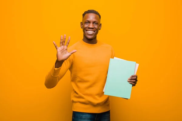 Young African American Black Man Orange Wall Book — Stock Photo, Image
