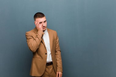 Genç yakışıklı iş adamı, sıkıcı, sıkıcı ve sıkıcı bir işin ardından sıkılmış, hayal kırıklığına uğramış ve uykulu hisseder.