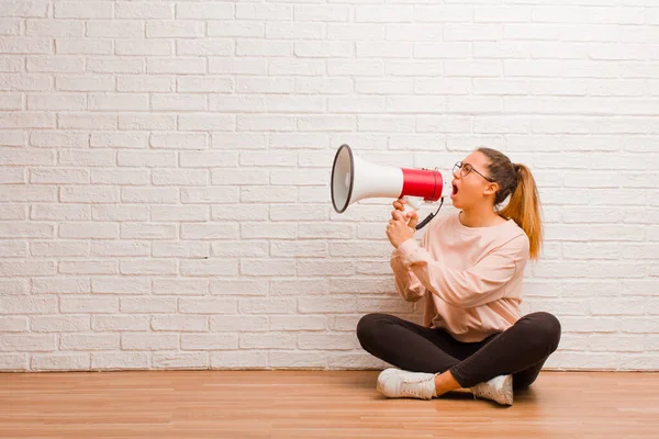 young pretty woman with a megaphone