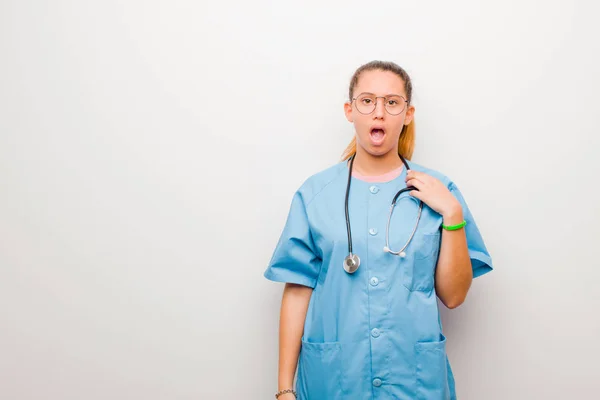 Young Latin Nurse Feeling Shocked Astonished Surprised Hand Chest Open — ストック写真