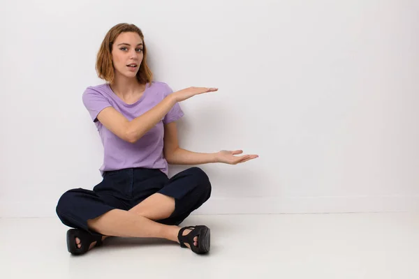 Young Blonde Woman Holding Object Both Hands Side Copy Space — Stock Photo, Image