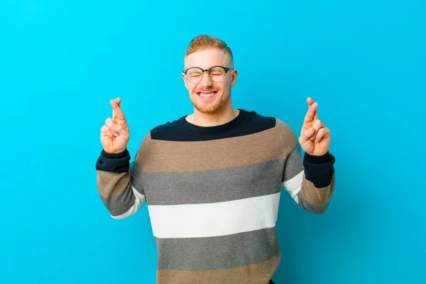 Young Blonde Man Smiling Anxiously Crossing Both Fingers Feeling Worried — Stok fotoğraf