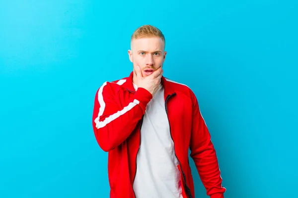 Young Blonde Man Wearing Sports Clothes Mouth Eyes Wide Open — Stock Photo, Image