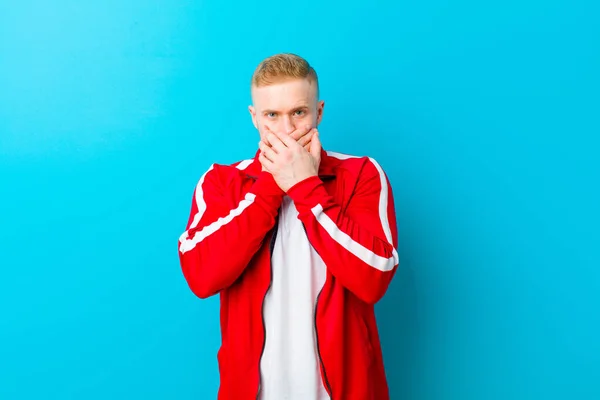 Young Blonde Man Wearing Sports Clothes Covering Mouth Hands Shocked — Stock Photo, Image