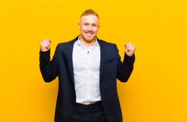 Genç sarışın iş adamı gururlu, haylaz ve kibirli hissederken şeytani bir plan kuruyor ya da bir numara düşünüyor.