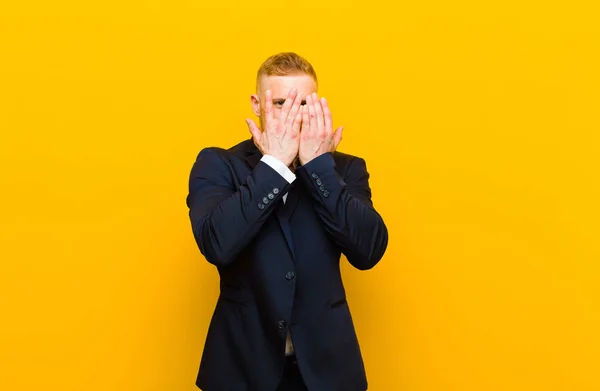 Young Blond Businessman Covering Face Hands Peeking Fingers Surprised Expression — Stock Photo, Image