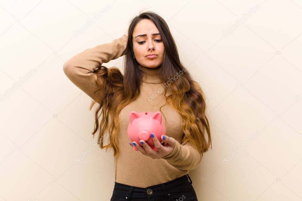 young pretty woman with a piggy bank