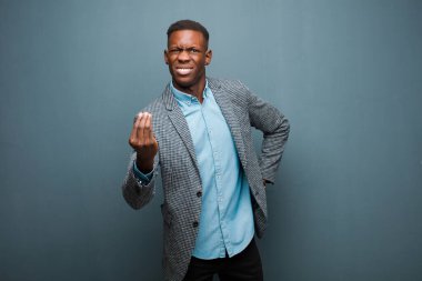 Genç Afrikalı Amerikalı siyahi adam kapiş ya da para hareketi yapıyor, sana borçlarını ödemeni söylüyor! grunge duvarına yaslan