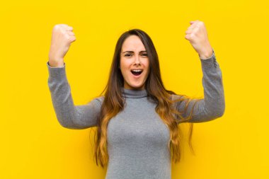 Genç ve güzel bir kadın inanılmaz bir başarıyı kutluyor. Kazanan gibi, heyecanlı ve mutlu görünüyor. Al bakalım! iş ya da iş kavramı