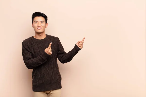 Young Chinese Man Smiling Happily Pointing Side Upwards Both Hands — Stock Photo, Image