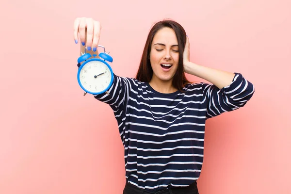 young pretty woman with a clock. time concept