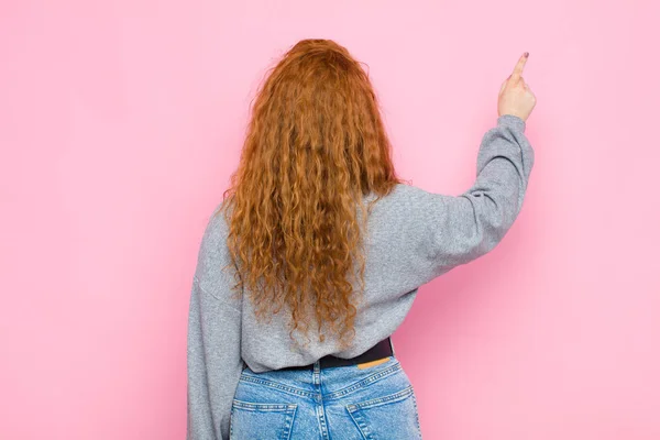 Young Red Head Woman Standing Pointing Object Copy Space Rear — Stock Photo, Image