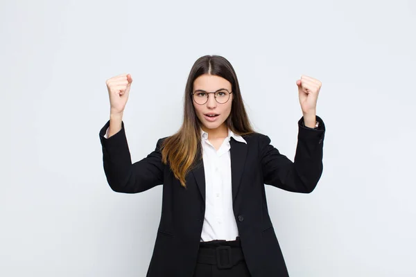 年轻的女商人像个成功者一样庆祝着令人难以置信的成功 看上去兴奋而快乐地说 拿去吧 相对于白墙 — 图库照片