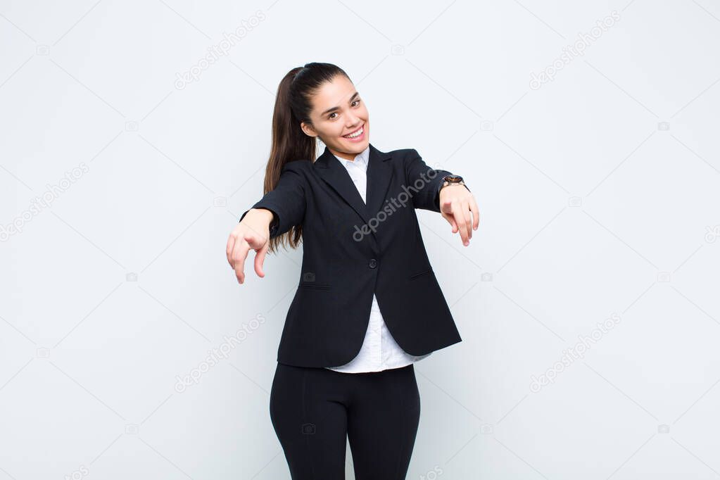 young pretty woman feeling happy and confident, pointing to camera with both hands and laughing, choosing you business concept