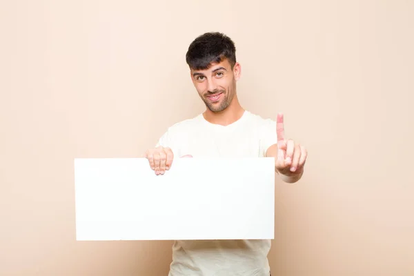 Young Handsome Man Smiling Proudly Confidently Making Number One Pose — Stockfoto