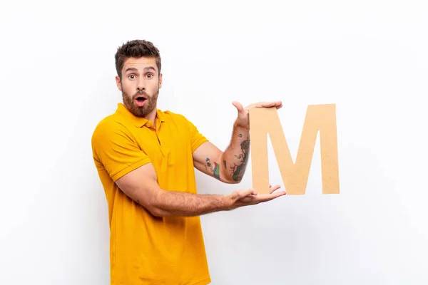 Young Handsome Man Surprised Shocked Amazed Holding Letter Alphabet Form — Stock Photo, Image