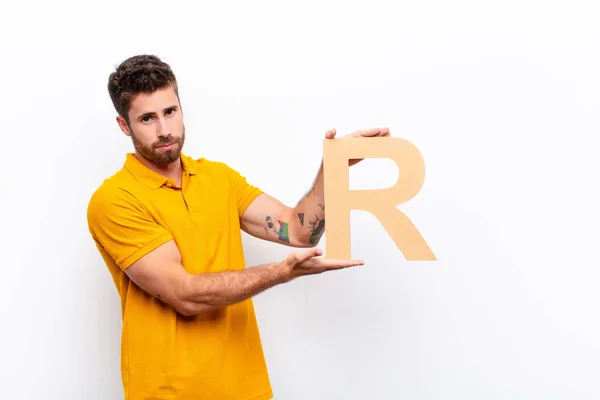 Joven Guapo Hombre Triste Deprimido Infeliz Sosteniendo Letra Del Alfabeto — Foto de Stock