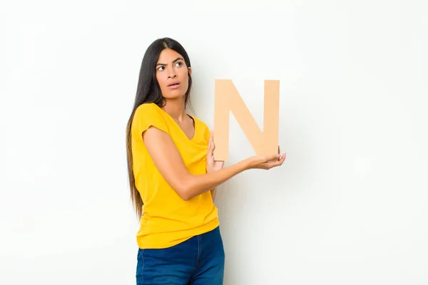 Young Latin Pretty Woman Surprised Shocked Amazed Holding Letter Alphabet — Stock Photo, Image