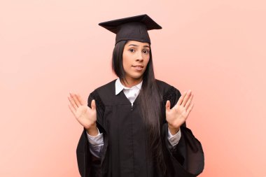 Genç Latin kız öğrenci gergin, endişeli ve endişeli görünüyor, benim hatam olmadığını söylüyor yoksa ben yapmadım. 