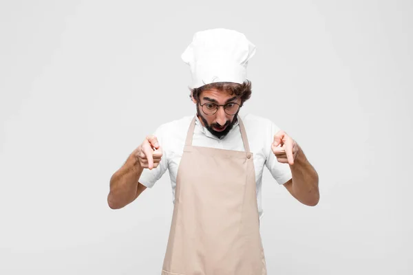 Young Crazy Chef Open Mouth Pointing Downwards Both Hands Looking — Stock Photo, Image