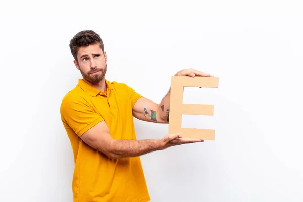 Young Handsome Man Confused Doubtful Thinking Holding Letter Alphabet Form — Stock Photo, Image