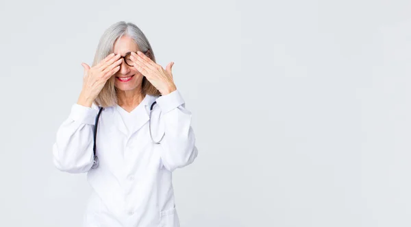 Mujer Doctora Mediana Edad Sonriendo Sintiéndose Feliz Cubriendo Los Ojos — Foto de Stock