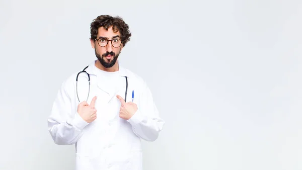 Young Doctor Man Pointing Self Confused Quizzical Look Shocked Surprised — Stock Photo, Image