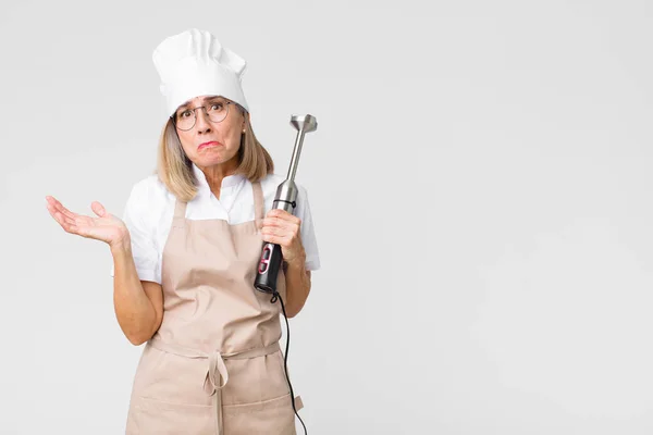 Middelbare Leeftijd Mooie Bakker Vrouw Met Een Mixer Tegen Kopieerruimte — Stockfoto