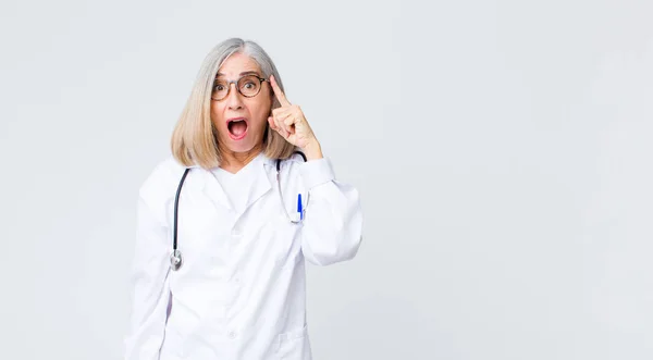 Middle Age Doctor Woman Looking Surprised Open Mouthed Shocked Realizing — Stock Photo, Image