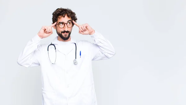 Young Doctor Man Feeling Confused Doubting Concentrating Idea Thinking Hard — Stock Photo, Image