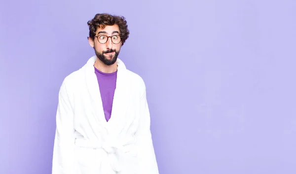 Young Bearded Man Wearing Bathrobe Looking Goofy Funny Silly Cross — Stock Photo, Image
