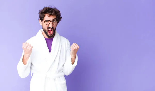 Young Bearded Man Wearing Bathrobe Shouting Aggressively Angry Expression Fists — Stock Photo, Image