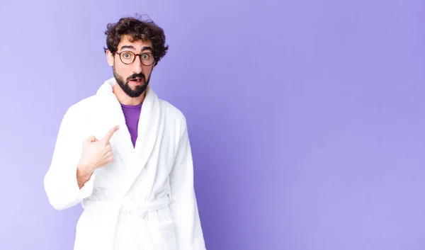 Young Bearded Man Wearing Bathrobe Feeling Confused Puzzled Insecure Pointing — Stock Photo, Image