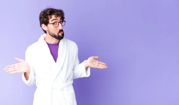 Young Bearded Man Wearing Bathrobe Feeling Puzzled Confused Unsure Correct — Stock Photo, Image