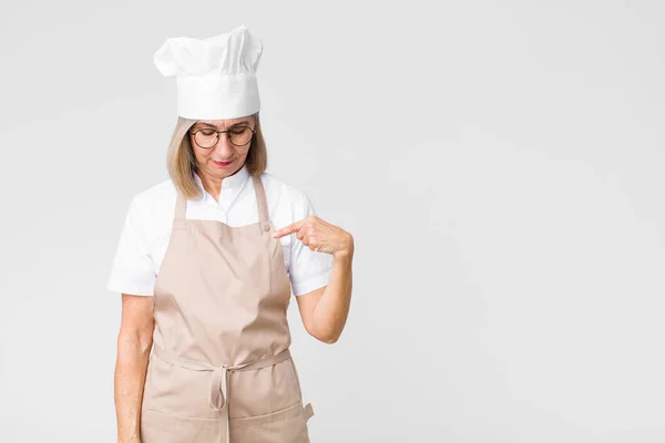 Middle Age Baker Woman Smiling Cheerfully Casually Looking Downwards Pointing — Stock Photo, Image