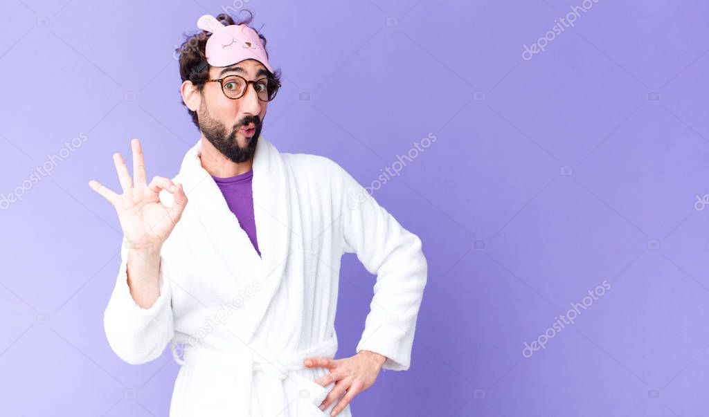 young crazy bearded man  wearing bathrobe and a sleep mask