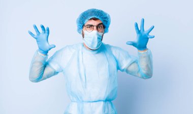 Delikanlı panik ya da öfke içinde bağırıyor. Şok olmuş, korkmuş ya da öfkeli. Elleri başının yanında. Coronavirus konsepti