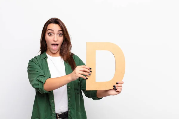 Young Pretty Woman Surprised Shocked Amazed Holding Letter Alphabet Form — Stock Photo, Image