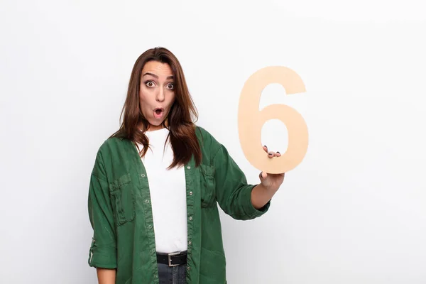 Young Pretty Woman Surprised Shocked Amazed Holding Number — Stock Photo, Image