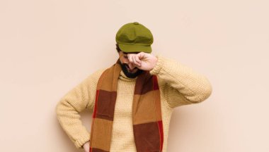 Aptal bir hata yaptıktan ya da hatırladıktan sonra kendini aptal gibi hissederek avuçtan avuca kadar yükselen sakallı genç adam.