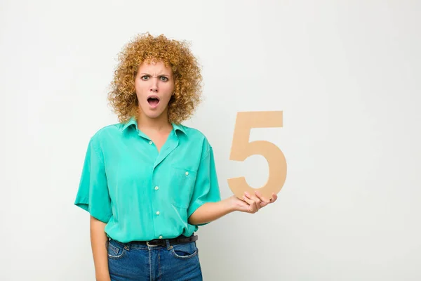 Young Pretty Afro Woman Confused Doubtful Thinking Holding Number — Stock Photo, Image