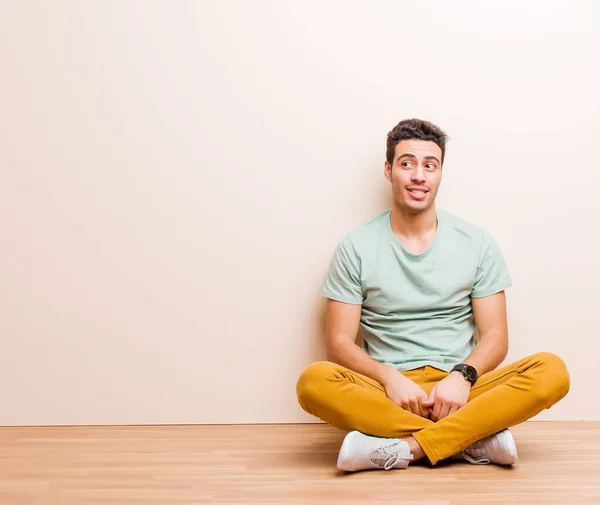 床に座っている若いアラビア人の男は心配し ストレスを感じ 不安を感じ パニックになり 歯を食いしばっていました — ストック写真